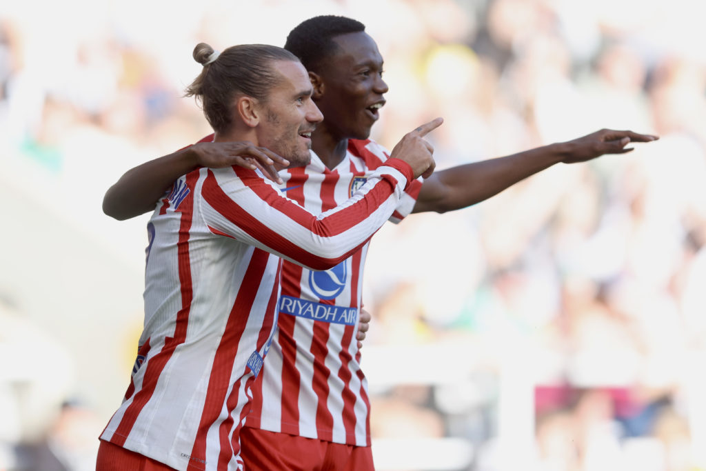 Antoine Griezmann and Taufik Seidu celebrate a goal for Atletico Madrid.