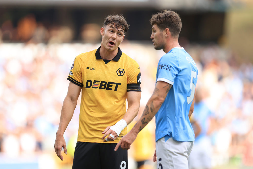 Jorgen Strand Larsen interacts with John Stones during Wolves vs Manchester City.