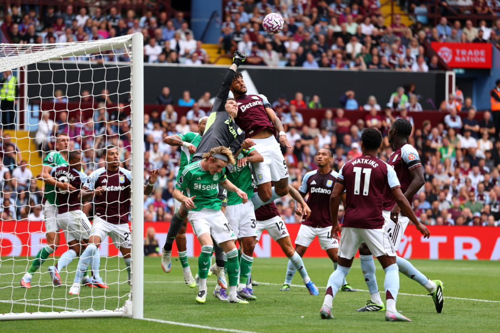 Newcastle United and Aston Villa players challenge for a corner during a Premier League game at Villa Park.