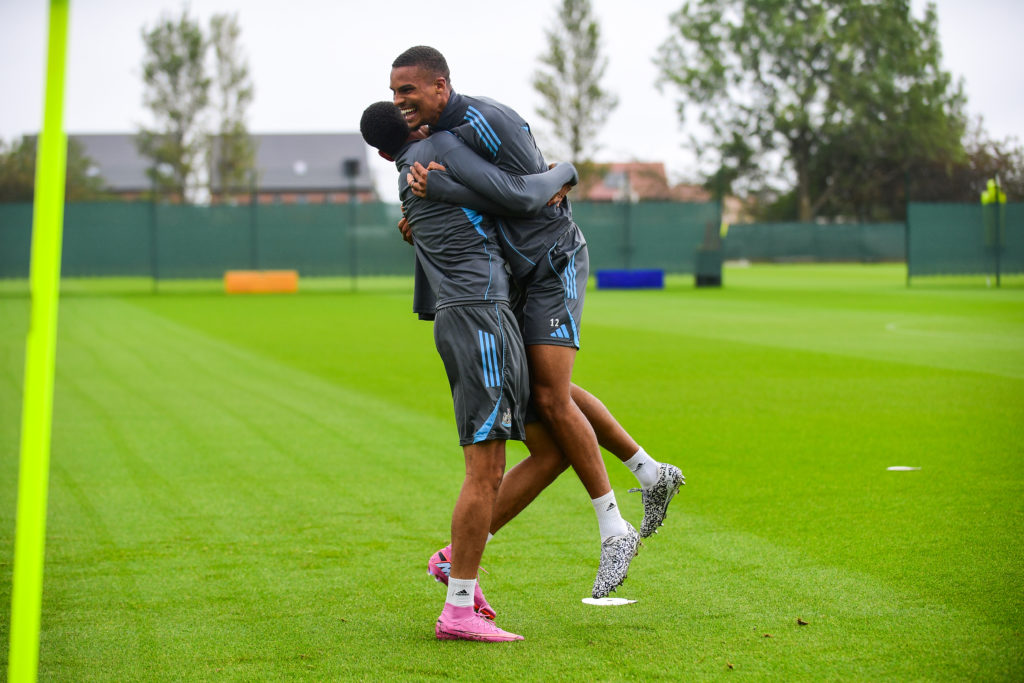 Malick Thiaw hugs a Newcastle United player during a training session.