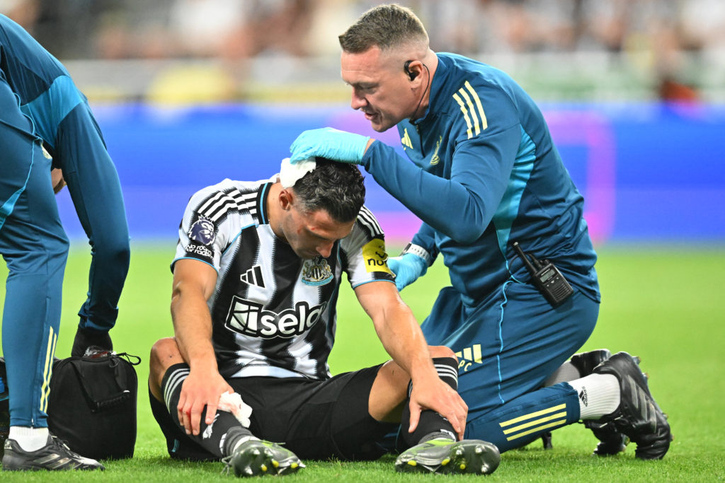 Fabian Schar receives treatment to his head after suffering an injury.