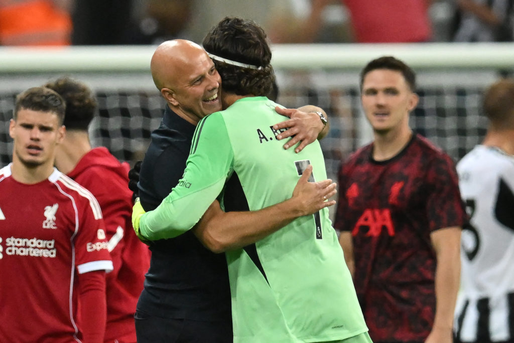 Arne Slot embraces Alisson Becker after a Premier League game between Newcastle United and Liverpool.