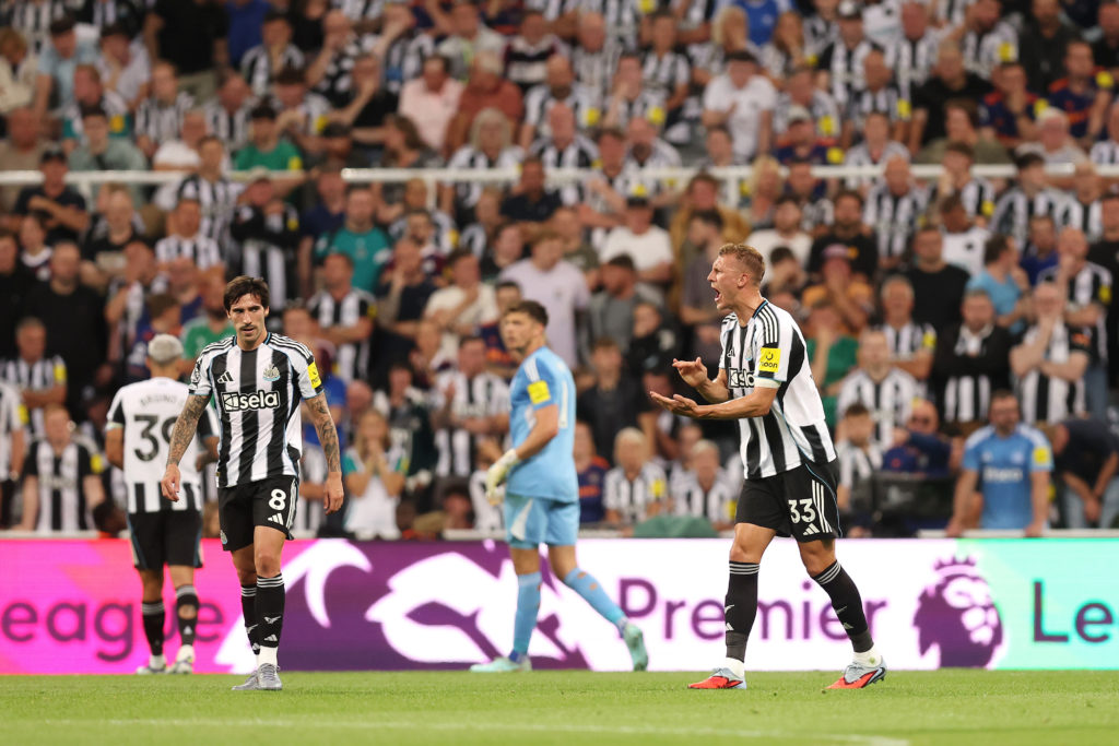 Dan Burn reacts after Liverpool score against Newcastle United in the Premier League.