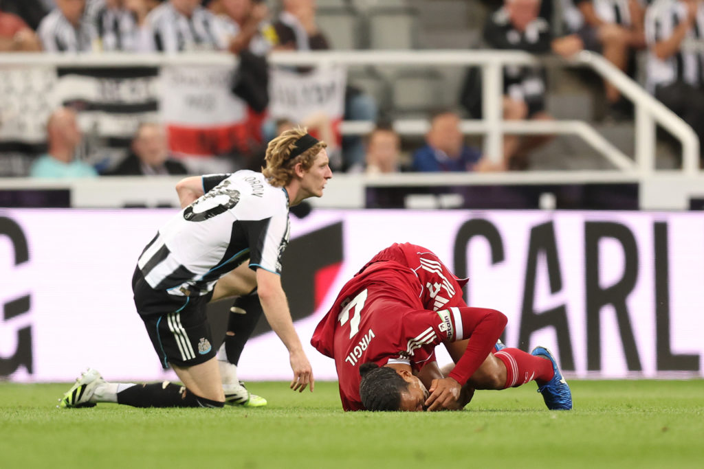 Anthony Gordon fouls Virgil van Dijk during a Premier League game between Newcastle United and Liverpool.