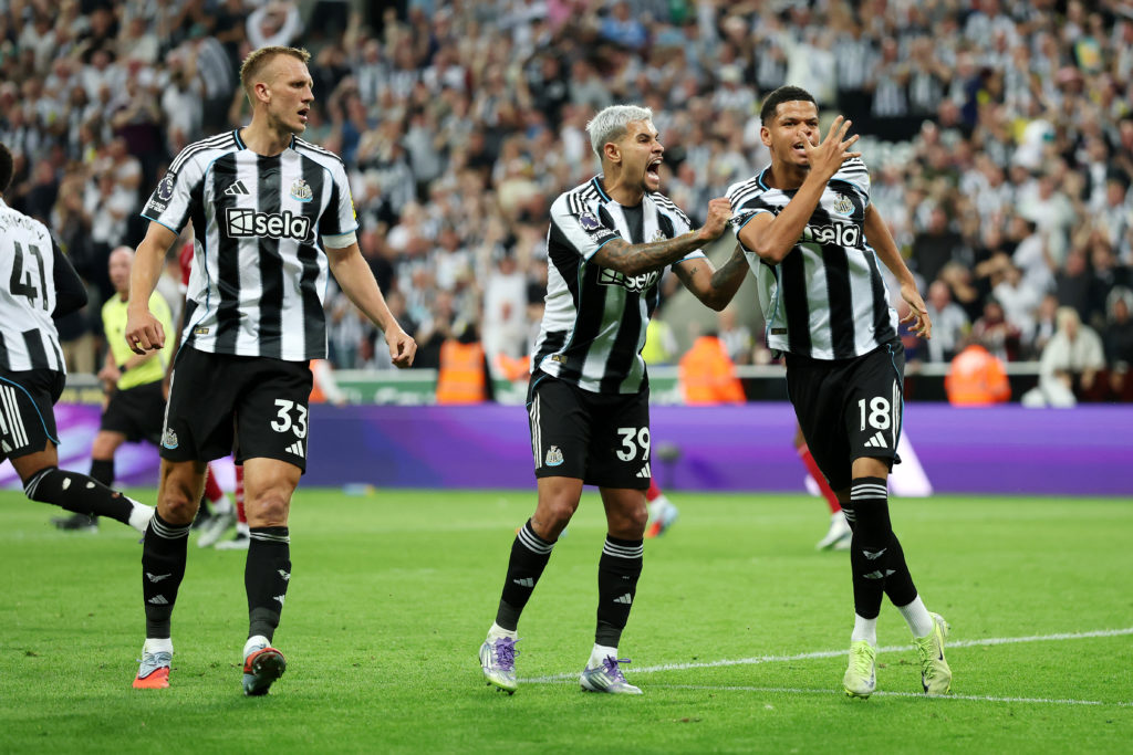 Will Osula celebrates with Bruno Guimaraes and Dan Burn after scoring for Newcastle United against Liverpool.