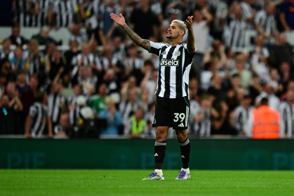 Bruno Guimaraes with his arms in the air during a Premier League game between Newcastle United and Liverpool.