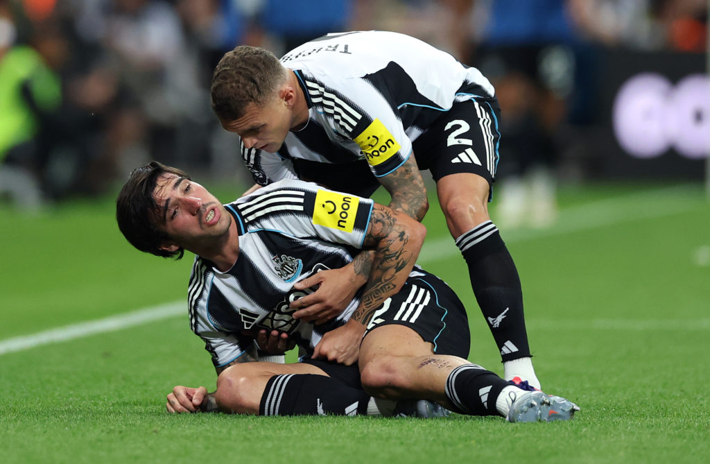 Sandro Tonlai is held by Kieran Trippier.