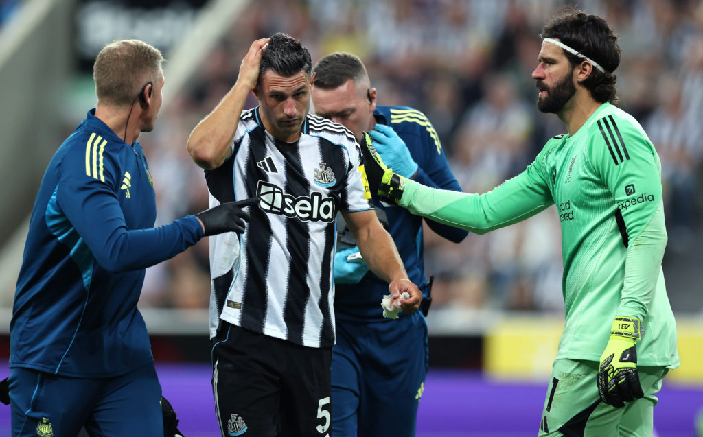 Fabian Schar goes off with a head injury during Newcastle United's Premier League game against Liverpool.