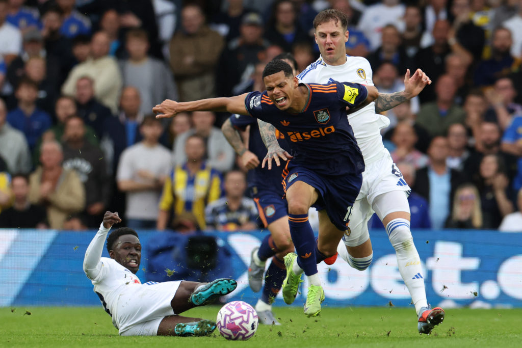 William Osula is tackled during a Premier League match between Leeds and Newcastle United.