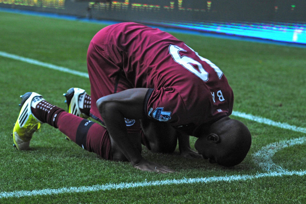 Demba Ba celebrates a goal by kissing the pitch.