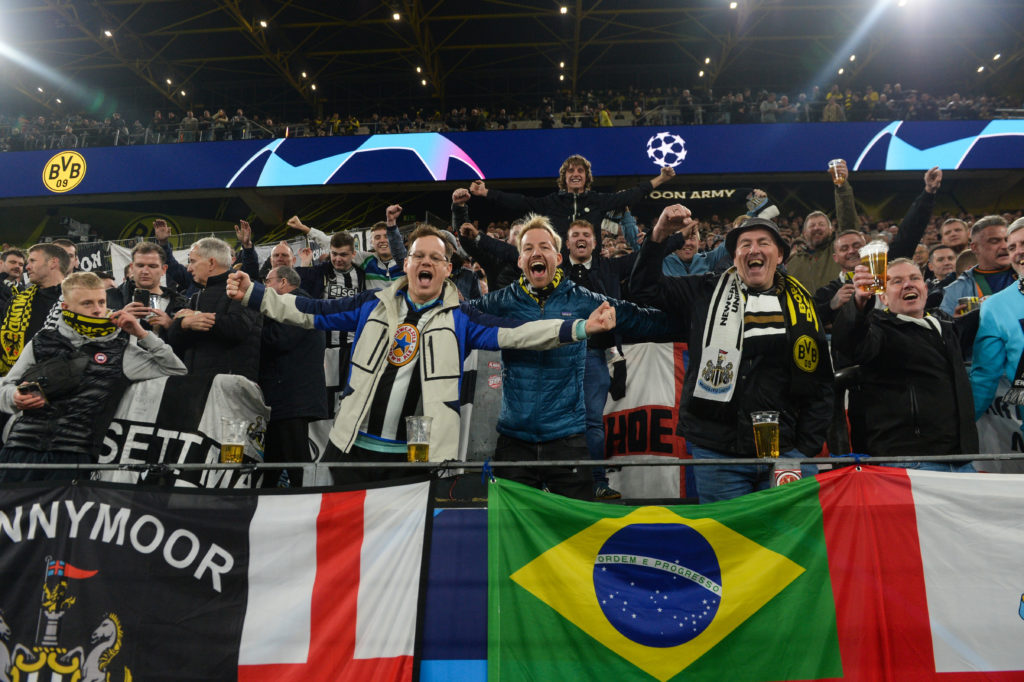 Newcastle United fans cheer on their team away from home against Borussia Dortmund in the Champions League.