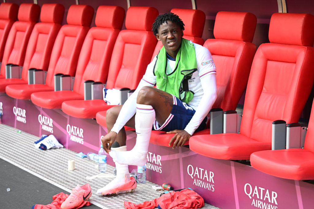Kobbie Mainoo looks on from the bench during a Euro 2024 game between England and Switzerland.