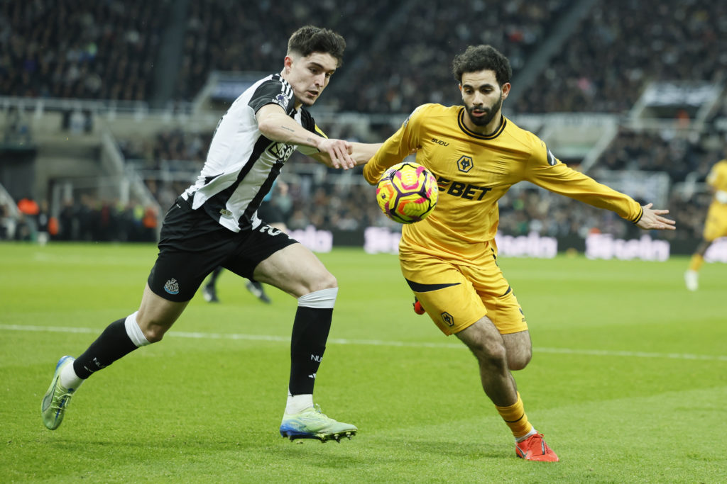 Tino Livramento tussles with Rayan Ait-Nouri during a Premier League game between Newcastle United and Wolves.