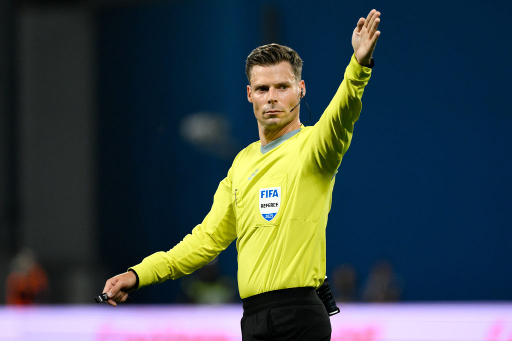 Referee Urs Schnyder gestures during a 2026 World Cup qualifier between Italy and Moldova.