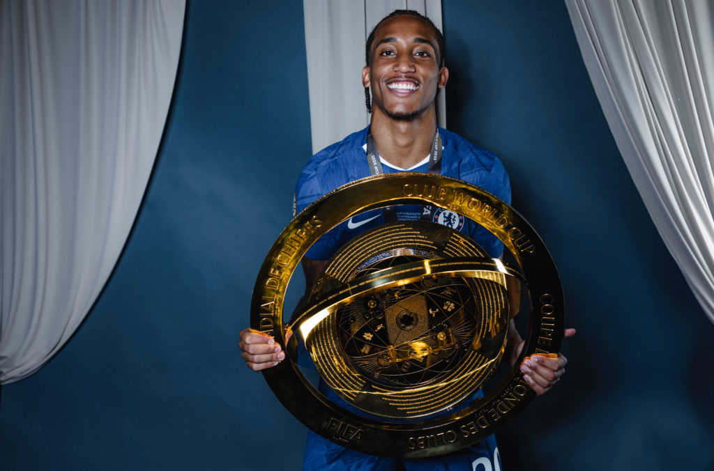 Chelsea forward Joao Pedro holds the FIFA Club World Cup trophy.