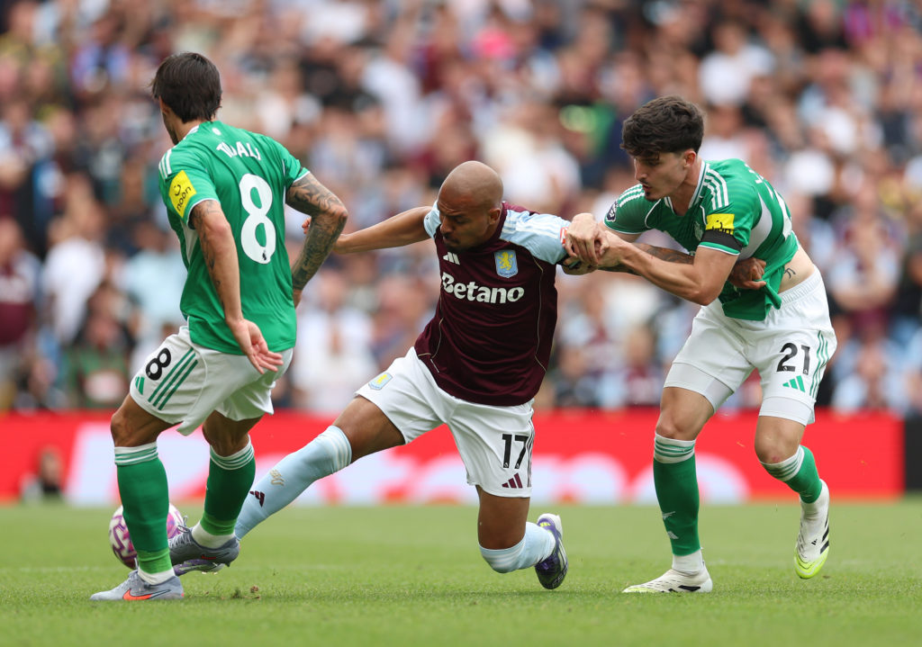 Sandro Tonali and Tino Livramento challenge Donyell Malen for the ball during Aston Villa vs Newcastle United.