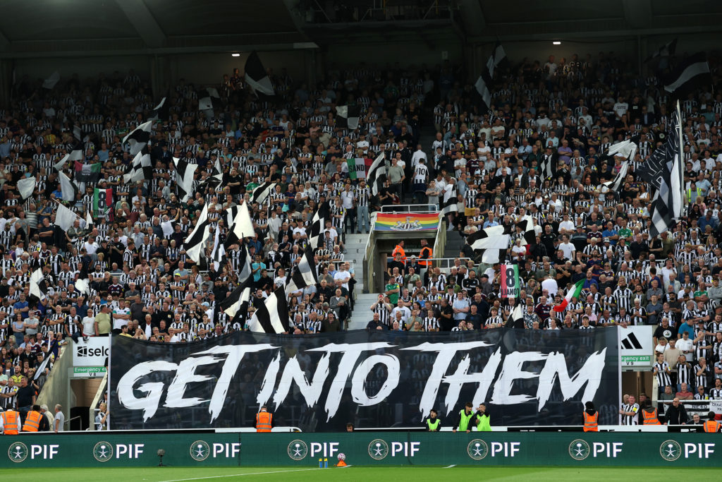 Newcastle United fans hold up a banner reading 'get into them' ahead of facing Liverpool in the Premier League.