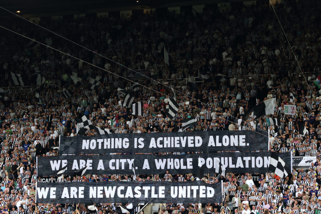 Newcastle United fans display a banner reading: 'nothing is achieved alone. we are a city. a whole population. we are Newcastle United'