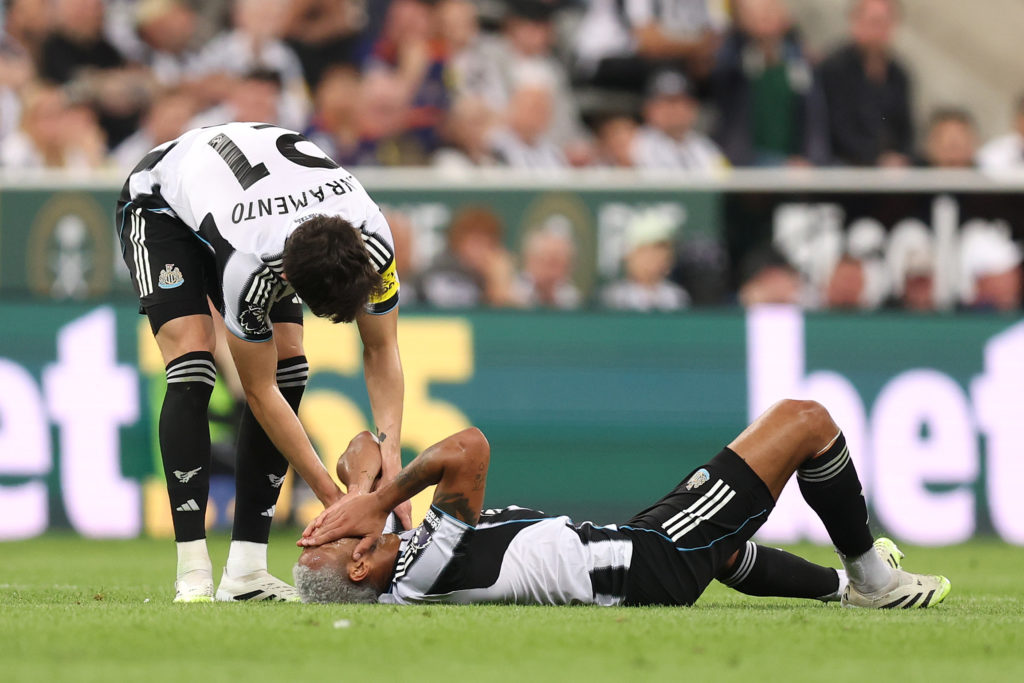 Tino Livramento helps Joelinton after he goes down with an injury during Newcastle United vs Liverpool.