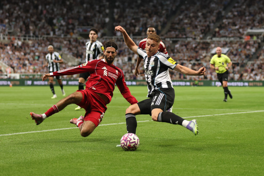 Harvey Barnes attempts a cross during Newcastle United's game against Liverpool.