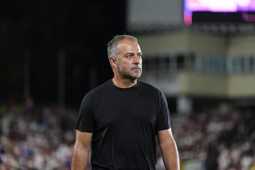 Hansi Flick looks on while managing Barcelona.