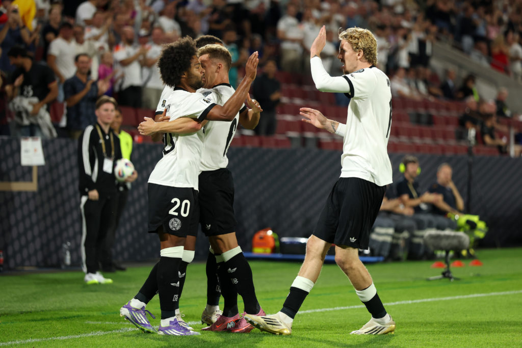 Nick Woltemade celebrates with Serge Gnabry after Germany score against Northern Ireland.