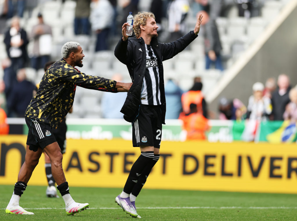 Joelinton pushes Nick Woltemade towards the fans after a Premier League game between Newcastle United and Wolves.