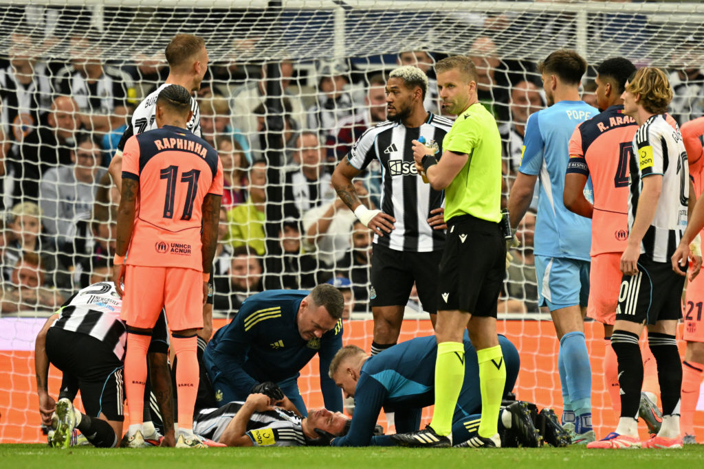 Fabian Schar receives treatment during a Champions League game between Newcastle United and Barcelona.