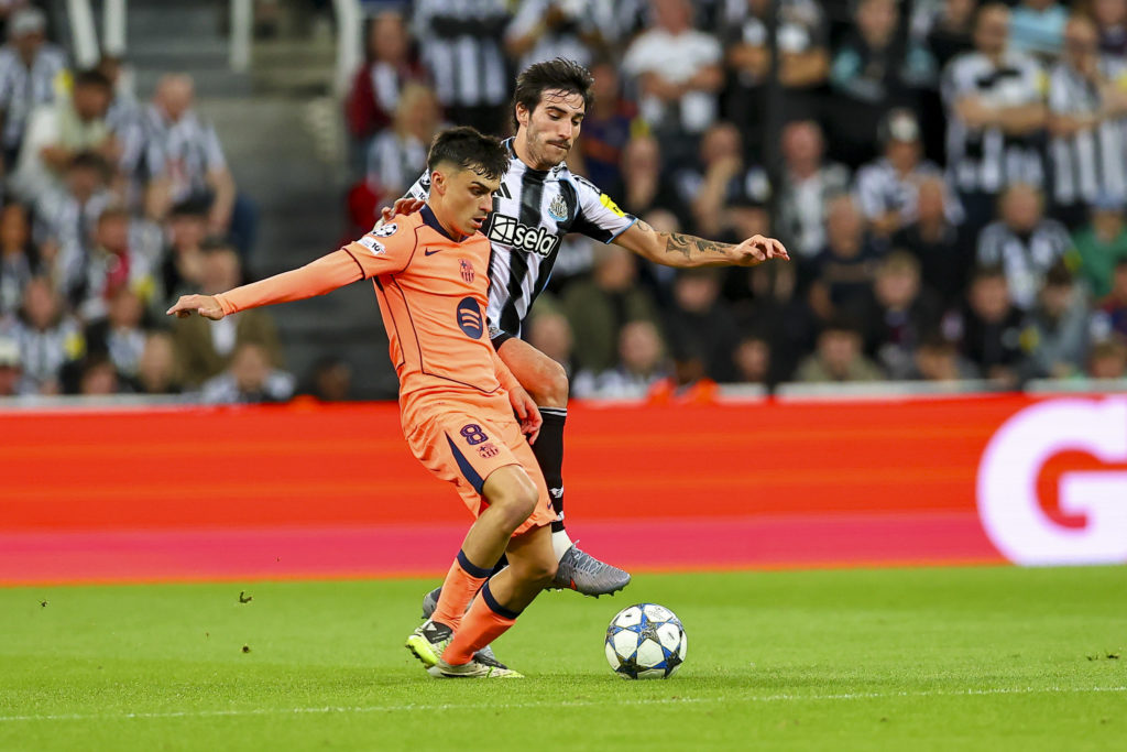Pedri shakes off a challenge from Sandro Tonali during a Champions League game between Newcastle United and Barcelona.