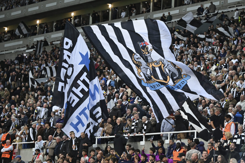 Newcastle United fans wave flags ahead of a Champions League game between Newcastle United and Barcelona.