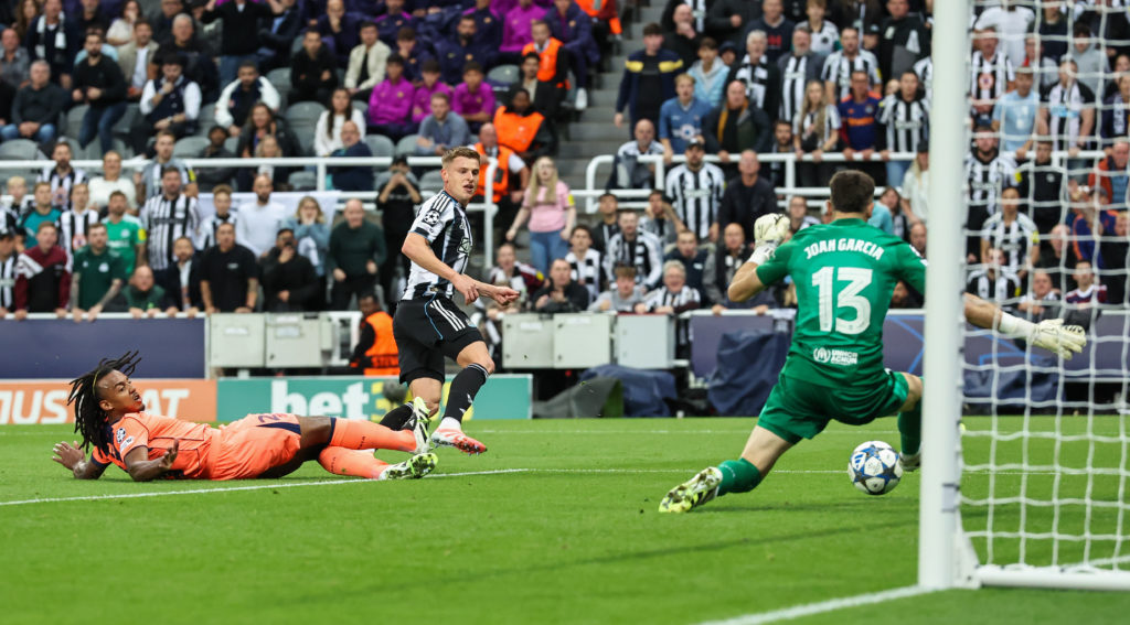 Joan Garcia saves an effort from Harvey Barnes during a Champions League game between Newcastle United and Barcelona.