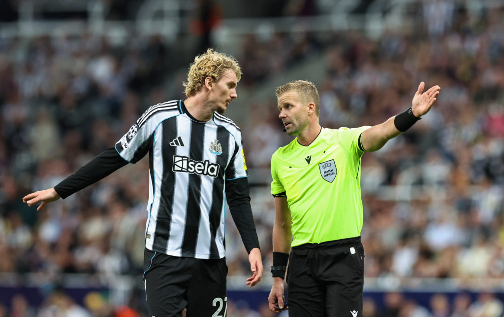 Nick Woltemade speaks to the referee during Newcastle United's Champions League game against Barcelona.