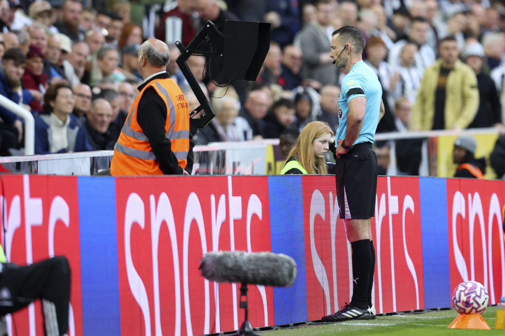 Jarred Gillett checks VAR monitor during the Premier League match between Newcastle United and Arsenal.
