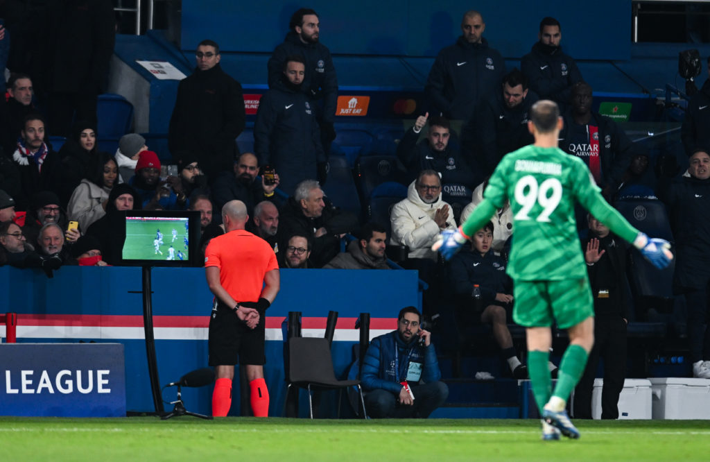 Szymon Marciniak checks the VAR screen during Paris Saint-Germain vs Newcastle United in the Champions League.