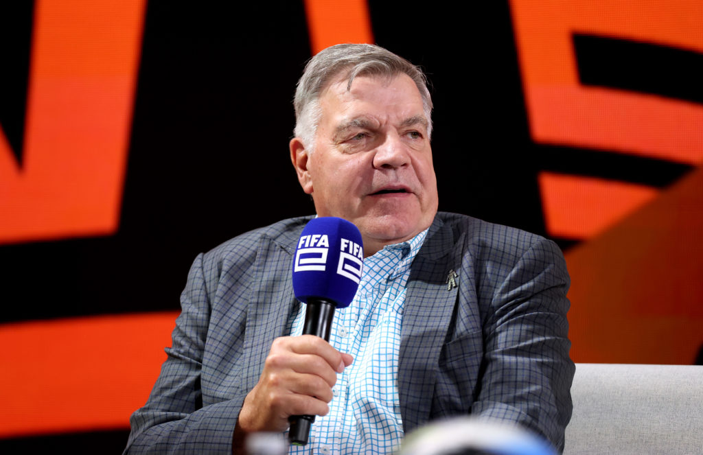 Sam Allardyce holds a microphone.