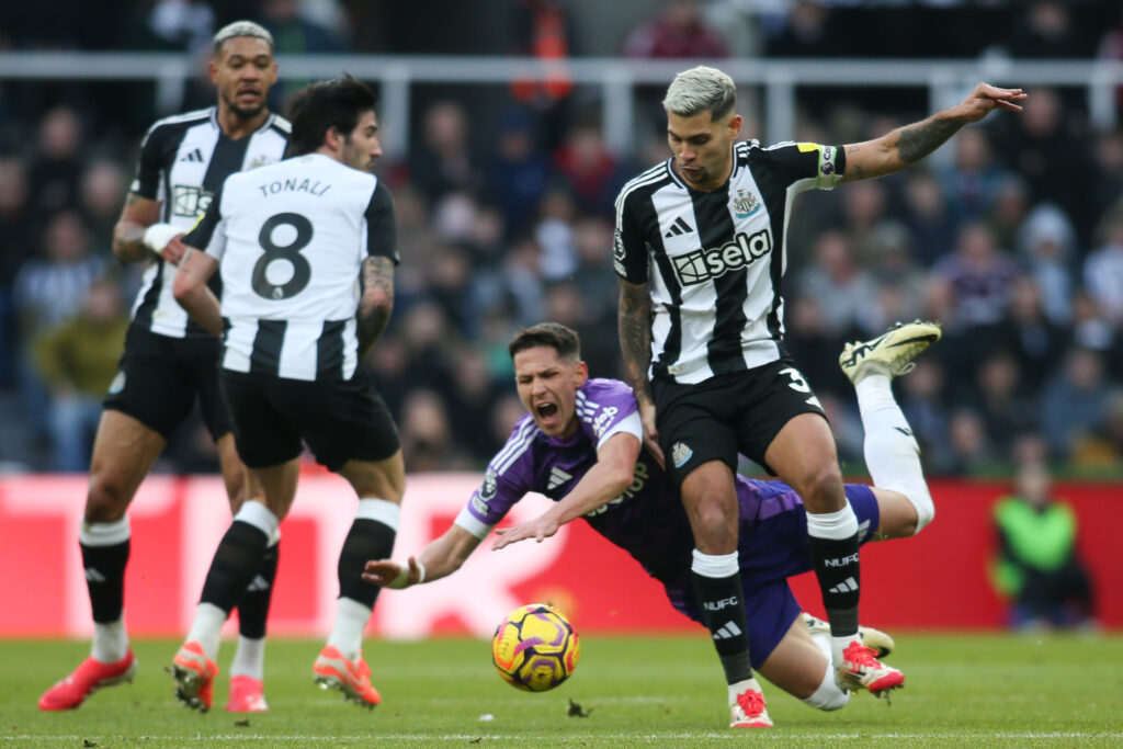 Bruno Guimaraes fouls Sasa Lukic during Newcastle United vs Fulham.