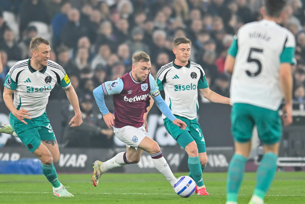 Harvey Barnes and Dan Burn chase Jarrod Bowen during West Ham vs Newcastle United.