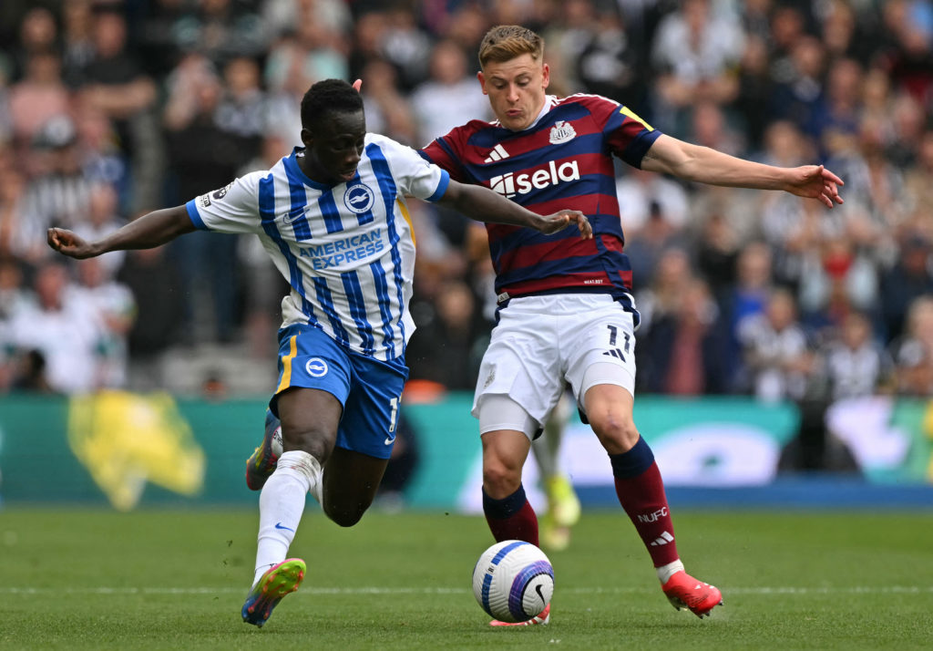 Harvey Barnes challenges Yankuba Minteh for the ball during Brighton vs Newcastle United.