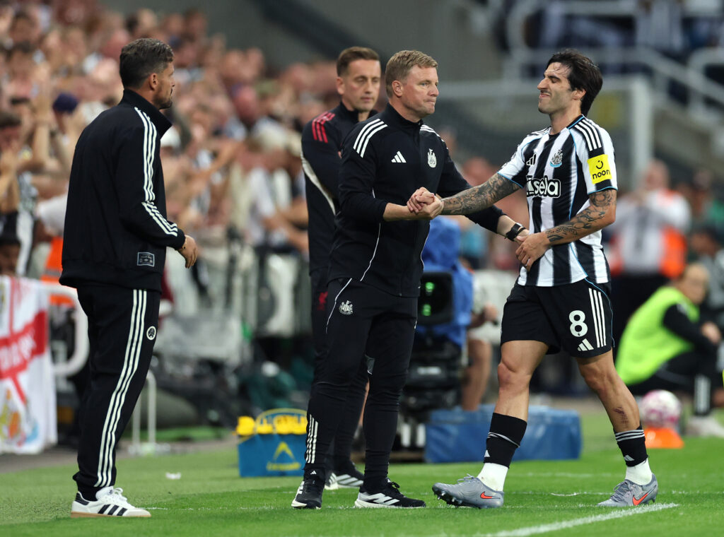 Eddie Howe shakes hands with Sandro Tonali after substituting him during Newcastle United vs Liverpool.