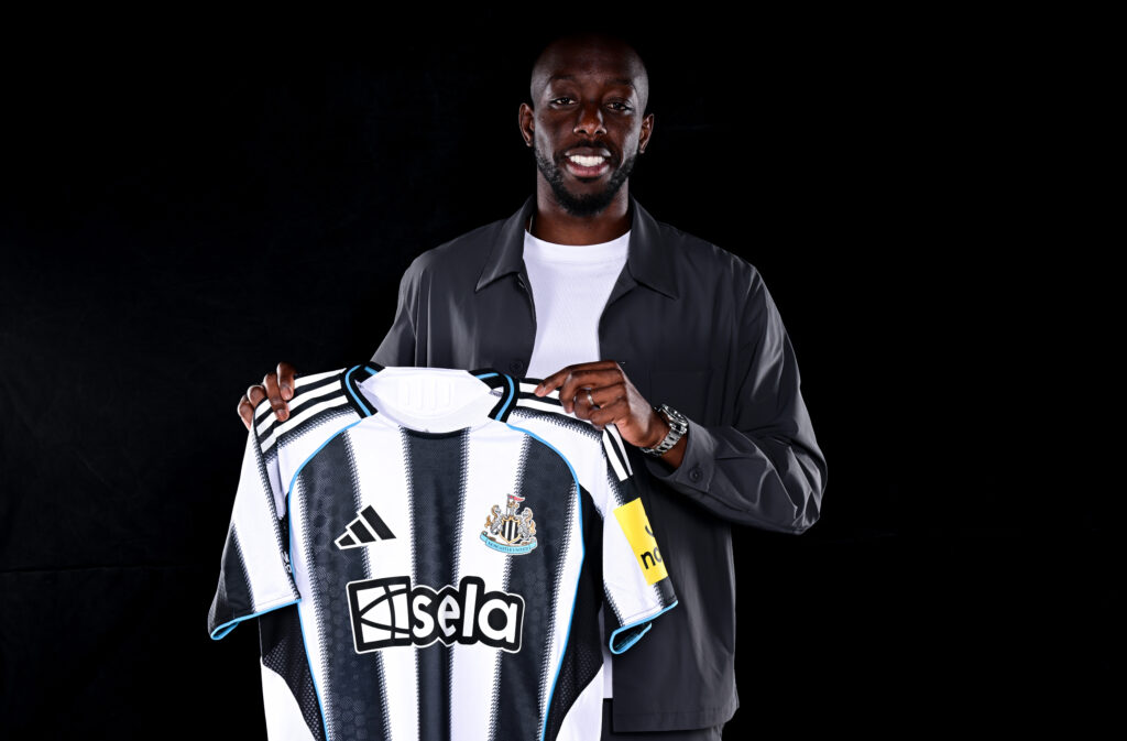 Yoane Wissa holds up a Newcastle United shirt after signing from Brentford.