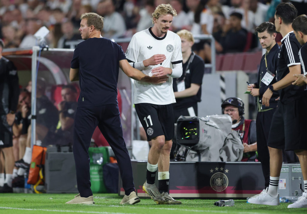 Nick Woltemade walks past Julian Nagelsmann.