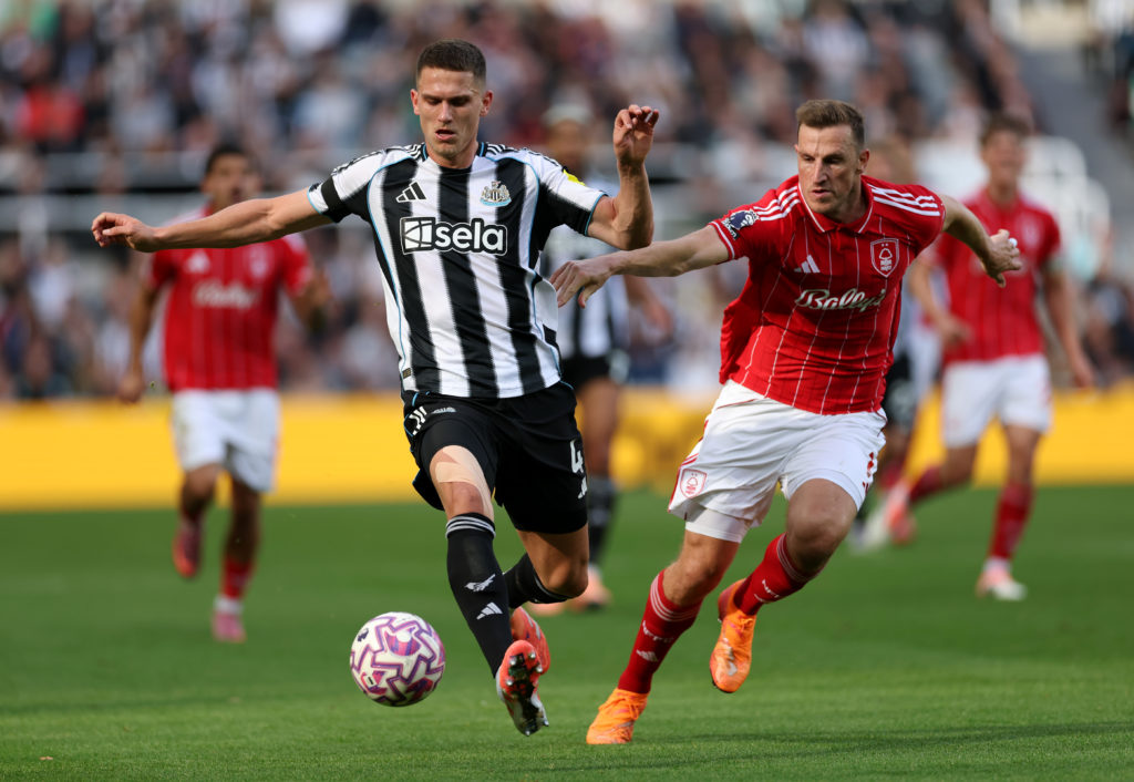 Sven Botman and Chris Wood battle for the ball during Newcastle United's game with Nottingham Forest.