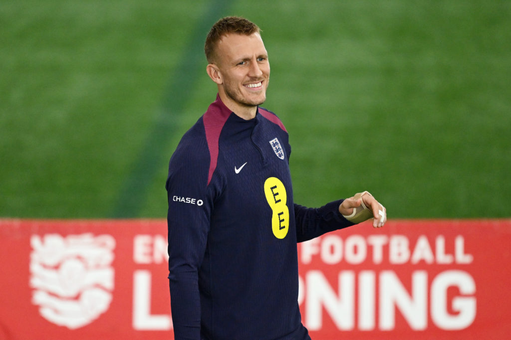 Dan Burn smiles in England training with a splint on his finger.