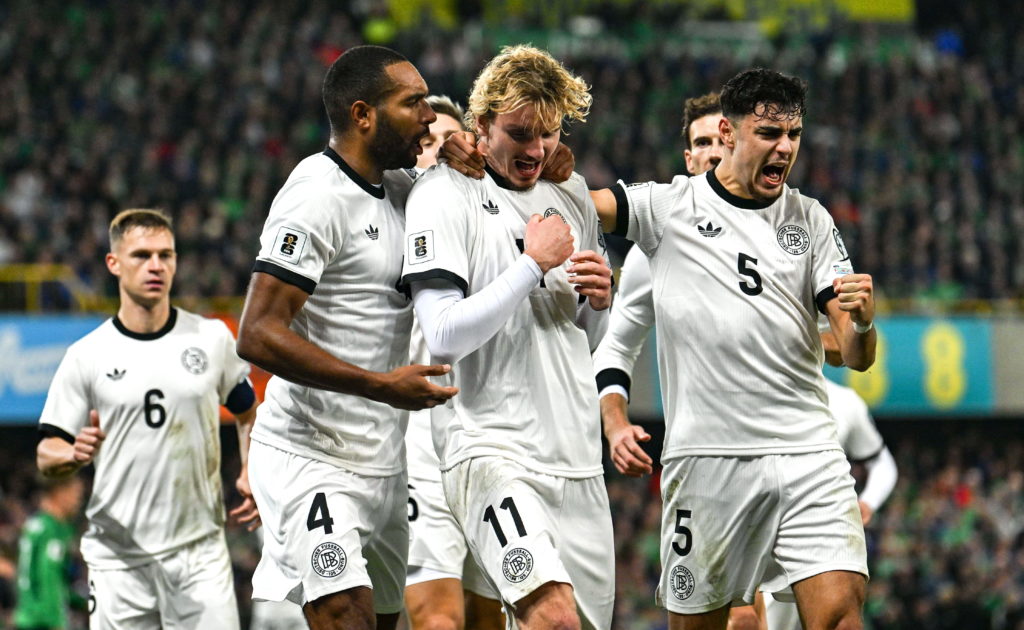 Germany players celebrate with Nick Woltemade.
