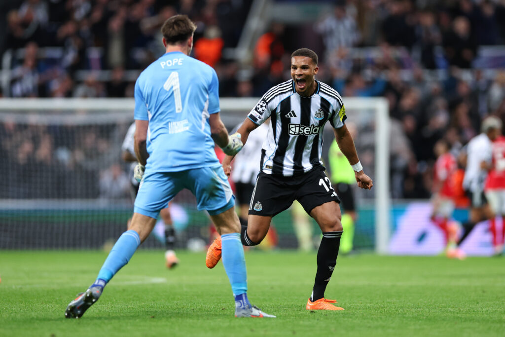 Malick Thiaw runs to celebrate with Nick Pope after the latter created Newcastle United's second goal against Benfica in the Champions League.