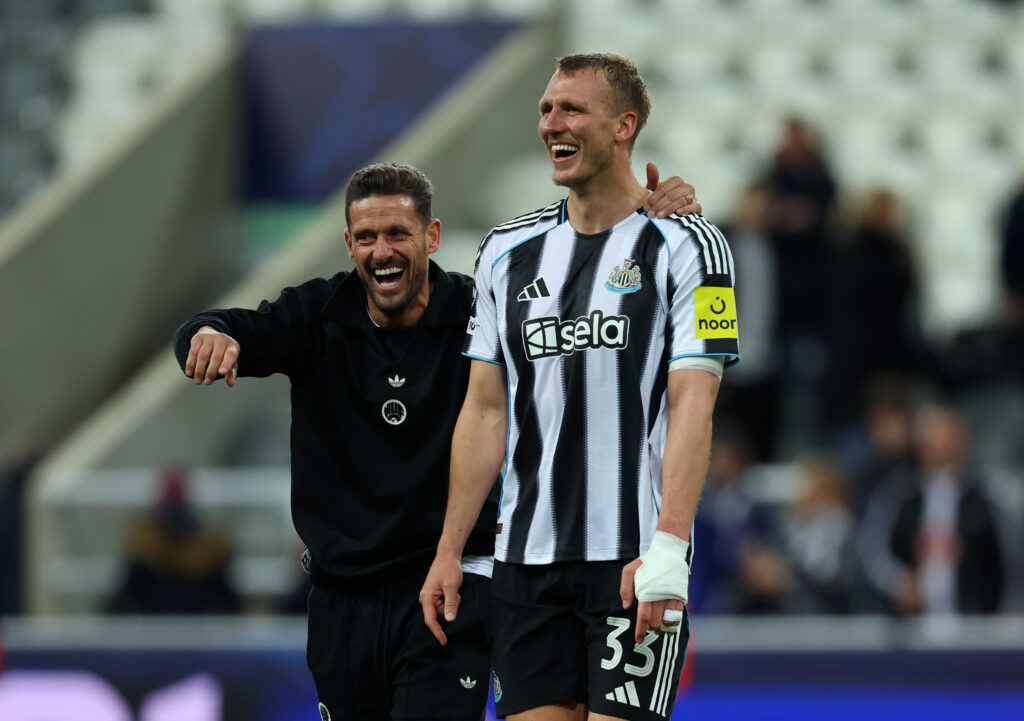 Dan Burn smiles alongside Jason Tindall after Newcastle United's Champions League win over Benfica.