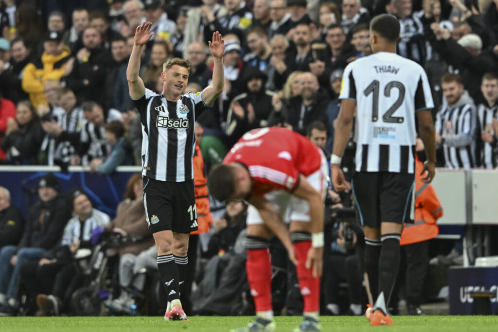 Harvey Barnes celebrates scoring a goal for Newcastle United against Benfica in the Champions League.