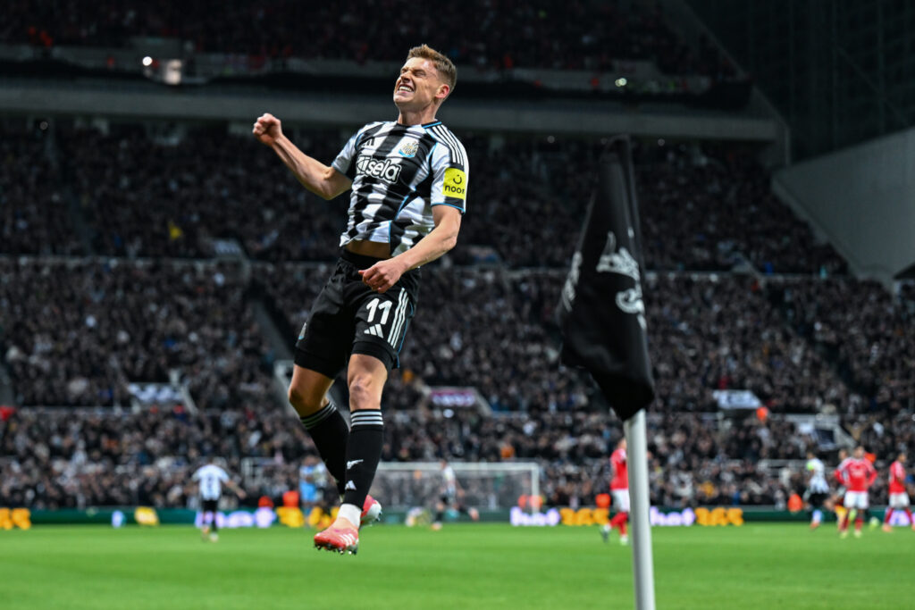 Harvey Barnes celebrates scoring for Newcastle United against Benfica in the Champions League.