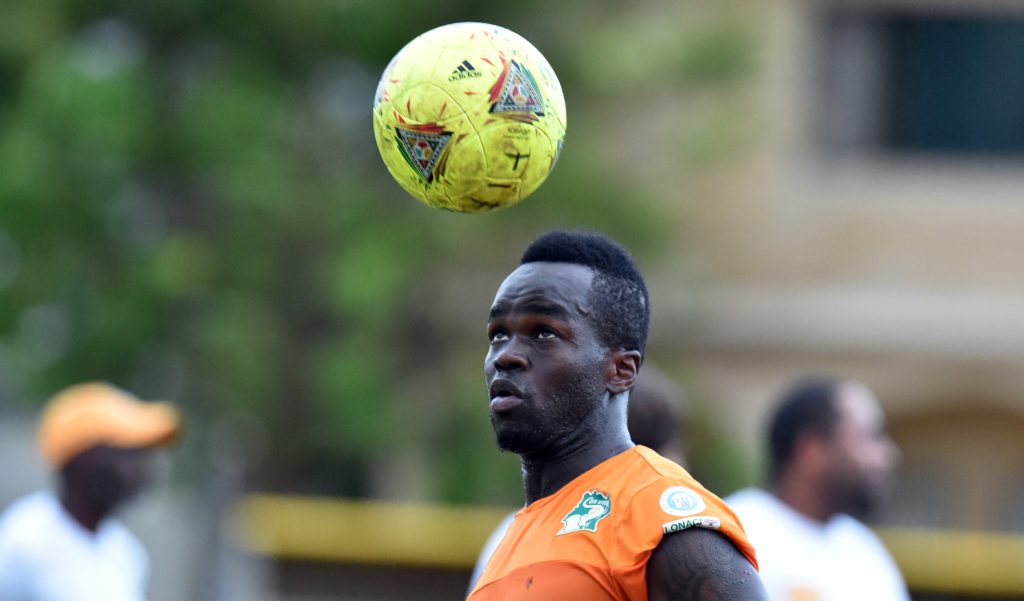Cheik Tiote heads a football in training.