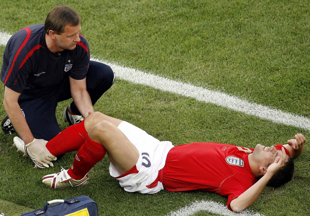 Michael Owen receives treatment after suffering an injury for England against Sweden in 2006.